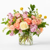 A soft, romantic presentation of blush and peach roses makes this flower