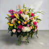A bright, cheerful mixed flower arrangement that makes anyone feel celebrated-perfect as