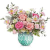 Pink and white mixed flower arrangement in a turquoise vase