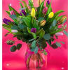 Vase of mixed-color tulips with lush foliage and ribbon on a bright pink background