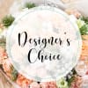 Round floral arrangement with pale pink and white blooms and pine accents