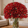Large bouquet of red roses in a clear glass vase