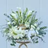 An airy, elegant sympathy flower arrangement built to honor a life with