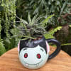 Succulent in a vampire face mug planter
