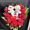 Red rose arrangement with two white teddy bears and a heart pillow