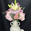 Pink and white floral arrangement in a white vase