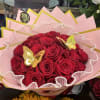 25 roses arranged into a round bouquet with the color paper of