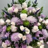 Large bouquet of pale pink roses, lavender chrysanthemums, and green button mums