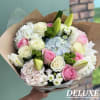 A beautifully curated deluxe bouquet featuring soft pink and white roses, delicate