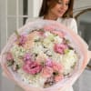 A lush, garden-style hand-tied bouquet that reads like a soft watercolor: Blush