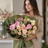 Layered pink and cream roses take center stage in this large hand-tied