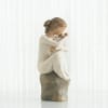 A quietly contemplative carved figurine in soft cream and taupe tones, this