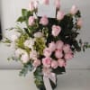 A charming pink flower arrangement in San Antonio featuring fresh pink roses