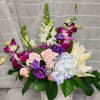 A beautiful array of dendrobium orchids, lilies, spray roses,  lisianthus, snapdragons