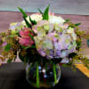 Bouquet of pastel hydrangeas and pink flowers in a glass vase