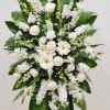 A serene white standing spray crafted to convey deep sympathy and quiet