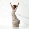 A hand-carved, sculptural figurine captures the spirit of celebration in this keepsake