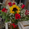 Bouquet of red roses and a sunflower with baby's breath