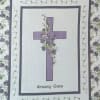Quilt with a purple cross and floral border, labeled 