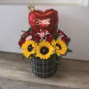 Birthday flower arrangement with sunflowers, red roses, and a heart balloon in a black container