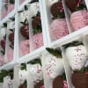 Boxes of chocolate-covered strawberries in pink, white, and dark chocolate