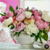 in ceramic vase combinations of different colors of peonies and garden roses