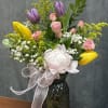 A soft and elegant blend of spray roses, tulips and a delicate