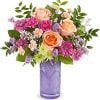 Peach roses, pink carnations, and purple pomps in a purple vase. 