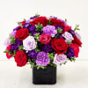 A rich, romantic cluster of red, purple, pink and white roses makes