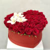 Heart-shaped box filled with red roses and white orchids