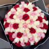 A lush dome of tightly packed roses in vivid red, blush pink