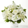 White floral arrangement in a white woven basket vase