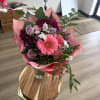 Pink and lavender bouquet in a glass vase with mixed blooms