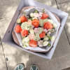 A refined bouquet blending warm peach roses with soft ivory blooms, delicate