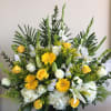 Yellow and white floral arrangement with roses, lilies, and daisies