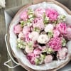A lush, romantic bouquet centered around premium pink peonies, accented with delicate