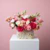A lush cluster of pink, white and peach blooms arranged in a