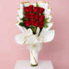 A dense cluster of classic red roses gathered into a tall hand-tied