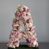 Large floral letter A covered in pink and white roses and orchids