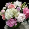 Mixed pink, white, and lavender bouquet in a glass vase