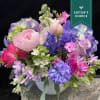 Pastel mixed flower arrangement in a white vase