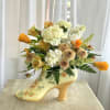 A ceramic shoe filled with flowers! This design features a yellow ceramic