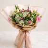Designed with a curated selection of seasonal blooms, including tulips and fresh