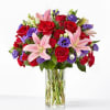 Vivid red roses and soft pink lilies make an immediate, romantic impression
