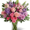 A lush combination of blush and hot pink roses with lavender and