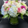 This cylindrical vase of flowers is kind of like a time capsule
