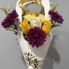 A bright handheld cone of flowers that reads like a joyful hug