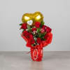 Glass vase wrapped in red paper, natural roses, heart-shaped balloon with a