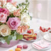 A charming pink flower box filled with a beautiful selection of mixed-tone