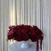 A lush mound of deep red roses and ranunculus creates the first